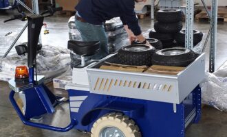 Ride-on electric tow tug handling materials