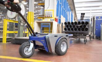 Standard-duty electric tow tug transporting materials