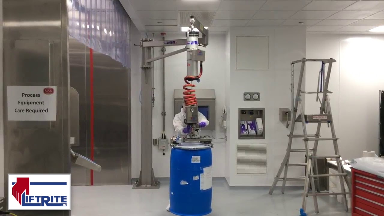 Installed stainless steel jib crane handling a drum in a controlled production area